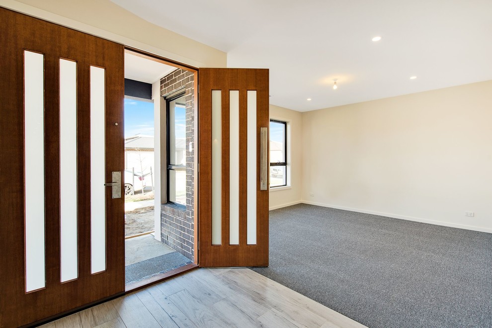 На фото: большая входная дверь в стиле модернизм с белыми стенами, деревянным полом, двустворчатой входной дверью, входной дверью из темного дерева и бежевым полом с
