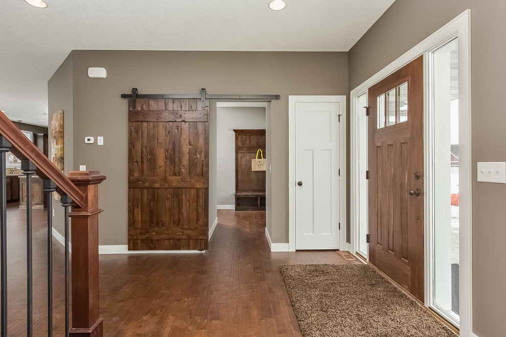 Entryway - mid-sized traditional medium tone wood floor entryway idea in Minneapolis with gray walls and a dark wood front door