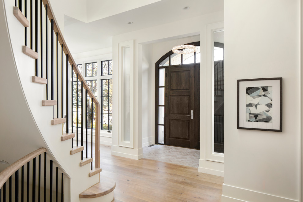 Classic entrance in Calgary with white walls, light hardwood flooring, a double front door and a black front door.