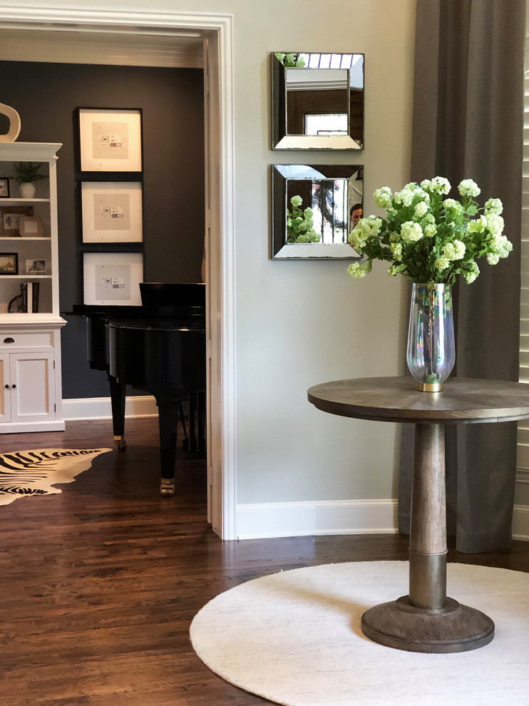 This is an example of a medium sized contemporary foyer in Dallas with grey walls, medium hardwood flooring, a single front door, a dark wood front door and brown floors.