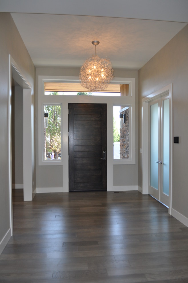 Contemporary foyer in Other with medium hardwood flooring, a single front door, a brown front door and grey walls.