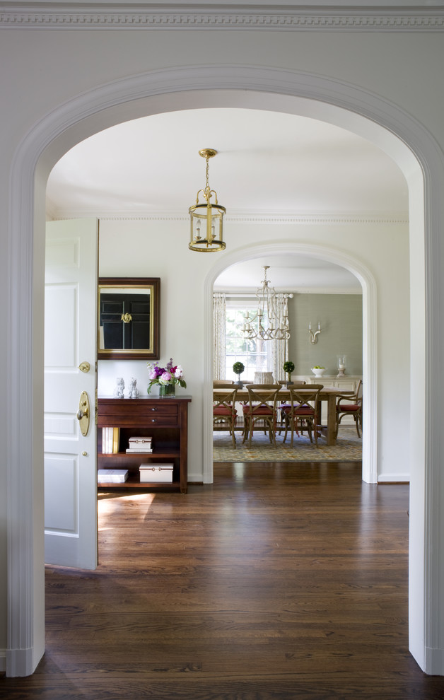 Elegant dark wood floor entryway photo in DC Metro with white walls and a white front door