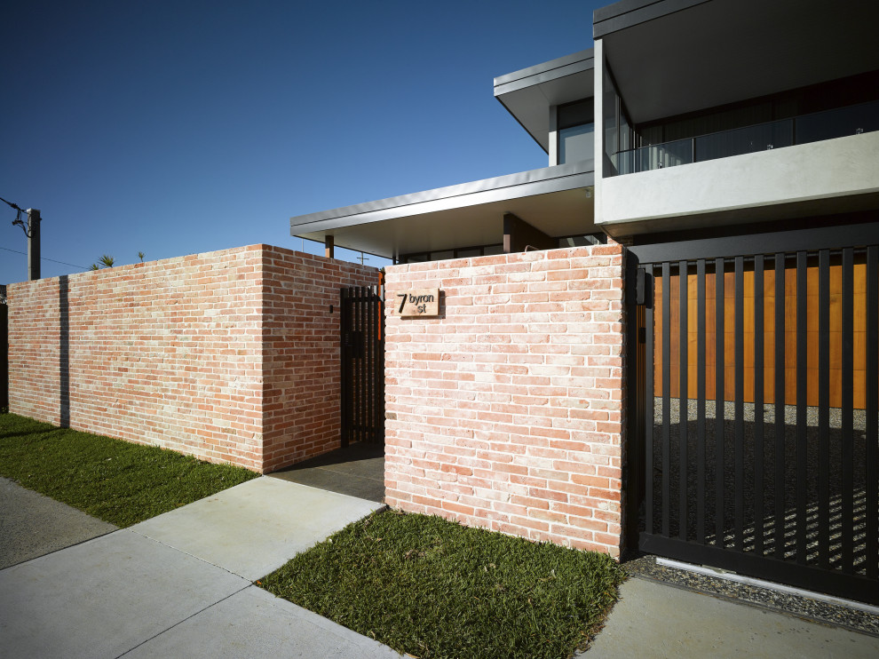 Inspiration for an urban entrance in Gold Coast - Tweed with granite flooring, black floors and brick walls.