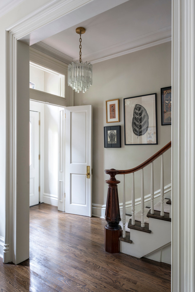 Mid-sized transitional dark wood floor and brown floor entryway photo in New York with beige walls and a white front door