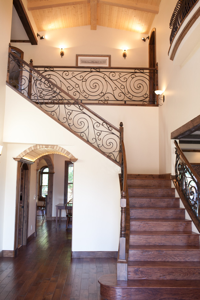 This is an example of a medium sized mediterranean foyer in Columbus with beige walls, dark hardwood flooring and brown floors.