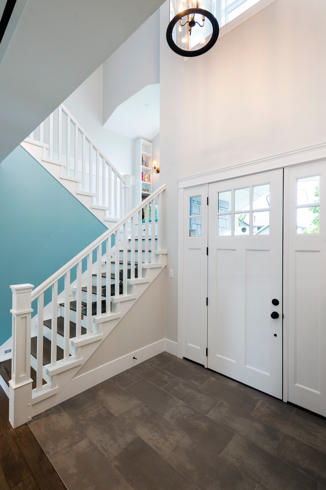 Inspiration for a mid-sized transitional porcelain tile entryway remodel in Vancouver with gray walls and a white front door