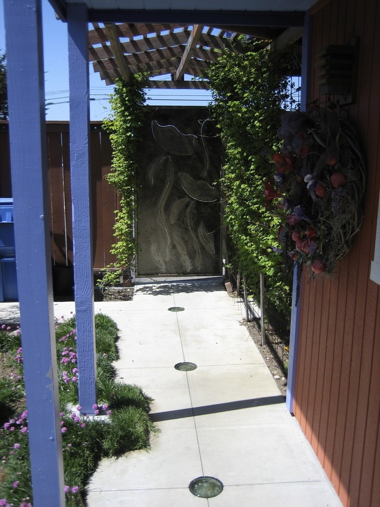 This is an example of a bohemian entrance in San Luis Obispo with a metal front door.