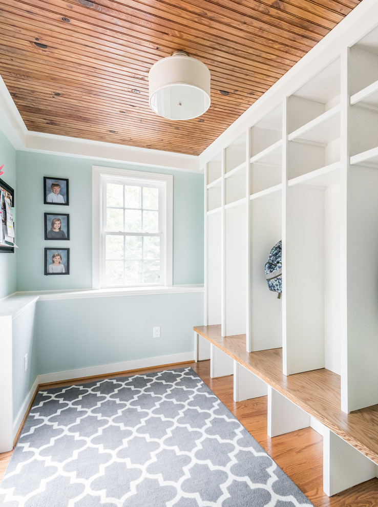 Medium tone wood floor entryway photo in Richmond with blue walls and a white front door