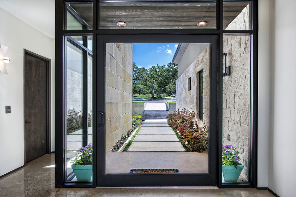 Design ideas for a contemporary front door in Austin with white walls, a pivot front door and a glass front door.