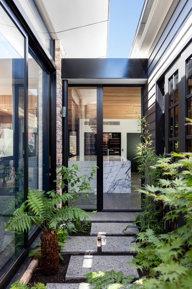 Design ideas for a contemporary front door in Wollongong with a glass front door.