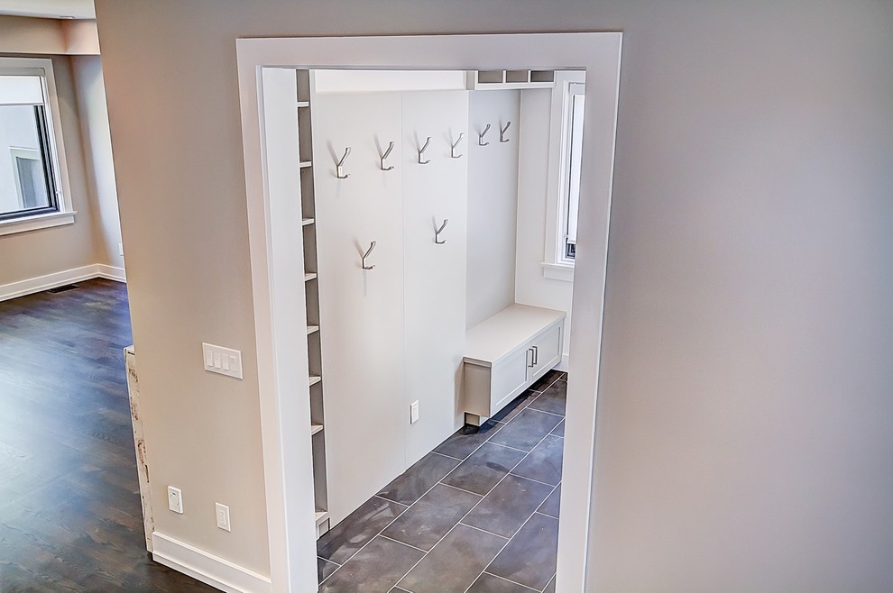 Large contemporary boot room in Toronto with grey walls, porcelain flooring and grey floors.