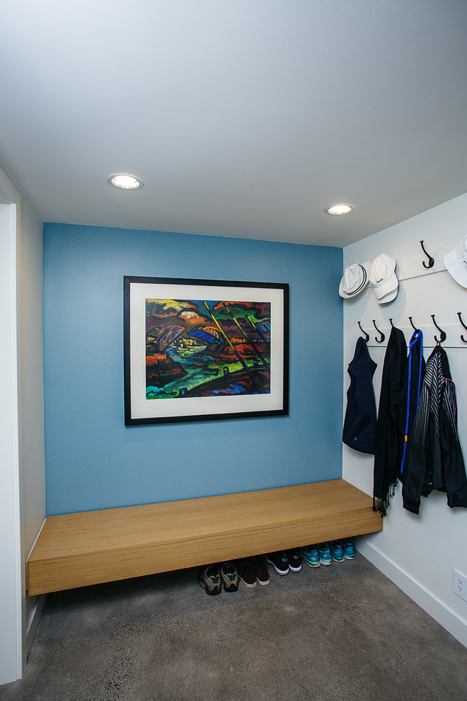 Inspiration for a small modern carpeted and beige floor entryway remodel in Portland with blue walls