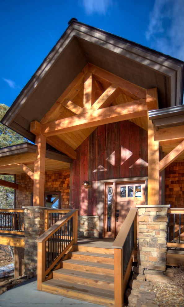 Mid-sized mountain style entryway photo in Denver with a medium wood front door