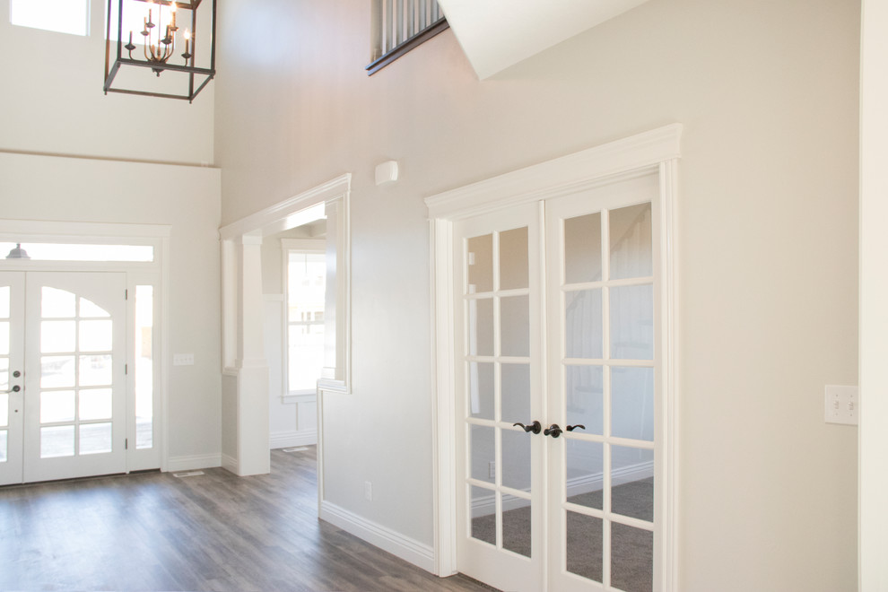Design ideas for a large classic foyer in Salt Lake City with grey walls, medium hardwood flooring, a double front door, a white front door and brown floors.