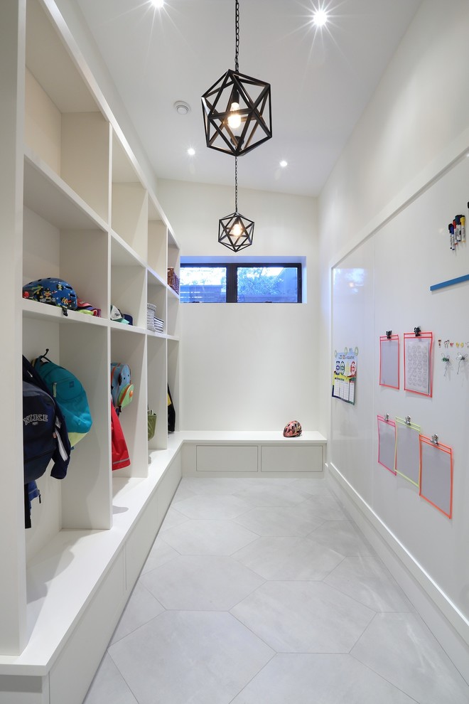 Photo of a large contemporary boot room in Vancouver with white walls and slate flooring.