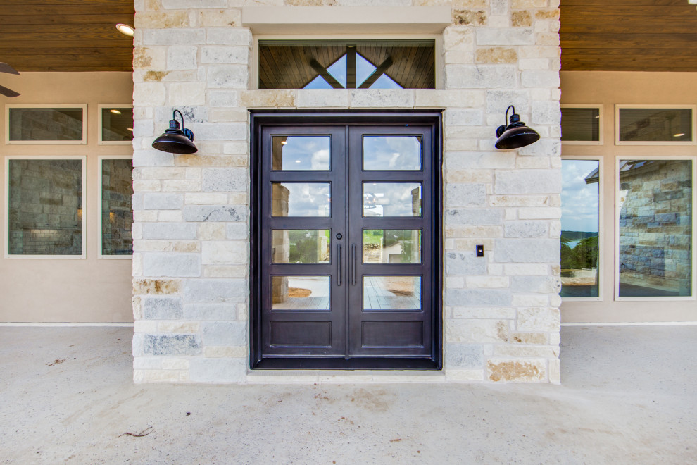 На фото: входная дверь среднего размера в стиле кантри с серыми стенами, бетонным полом, двустворчатой входной дверью, входной дверью из темного дерева и серым полом с
