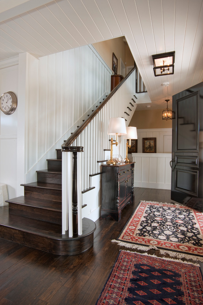 Inspiration for a traditional hallway in San Diego with a single front door, beige walls, dark hardwood flooring and feature lighting.