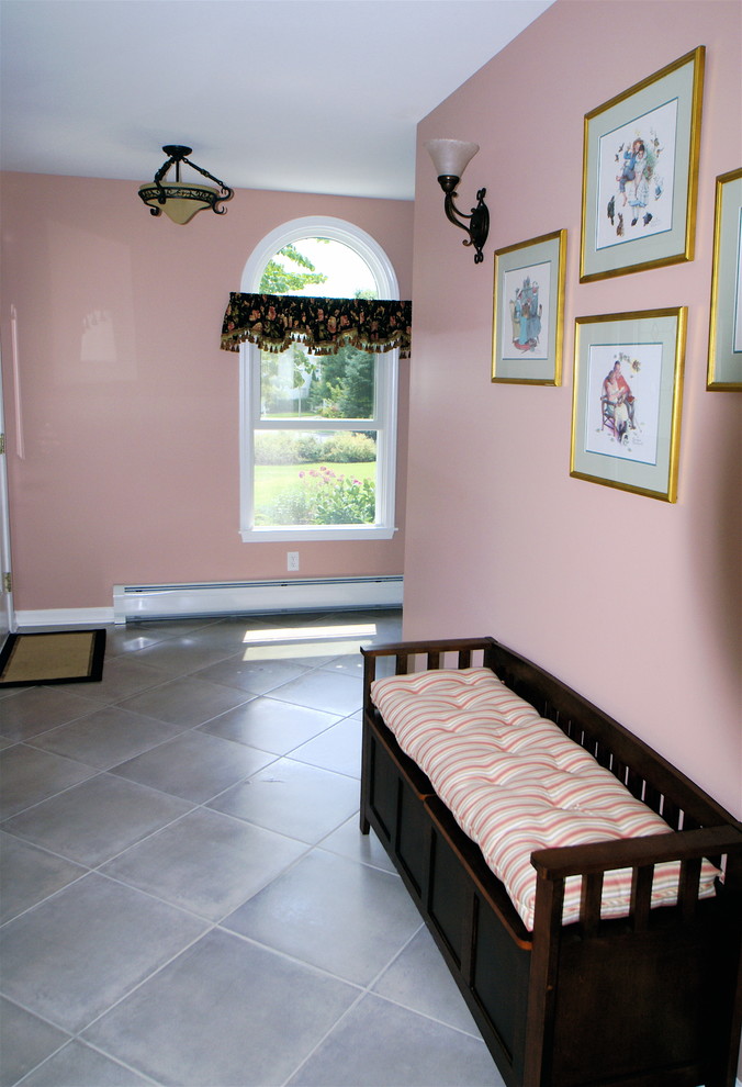 This is an example of a medium sized traditional hallway in Newark with pink walls and ceramic flooring.