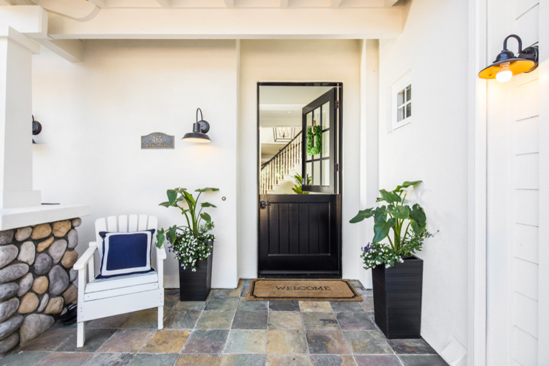 Inspiration for a mid-sized slate floor entryway remodel in San Diego with white walls and a black front door