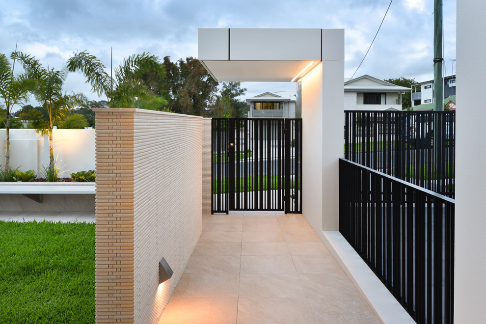 Photo of a large modern entrance in Brisbane with porcelain flooring and beige floors.