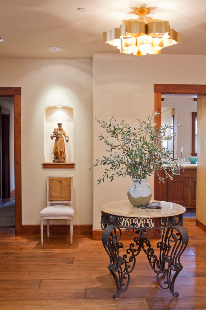 Example of a mid-sized mountain style medium tone wood floor entryway design in Hawaii with white walls and a medium wood front door
