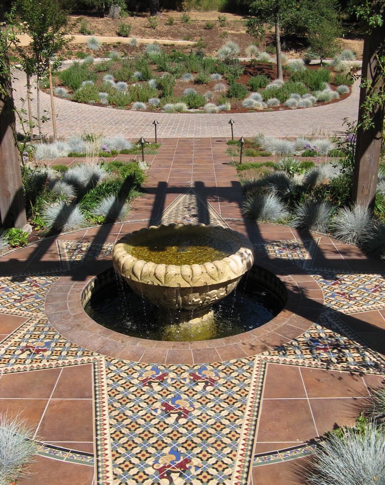 Inspiration for a large mediterranean front door in Denver with beige walls, terracotta flooring, a double front door and a glass front door.