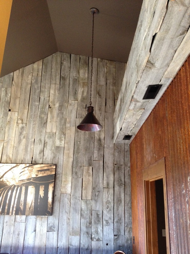 Photo of a medium sized rustic boot room in Other with grey walls.