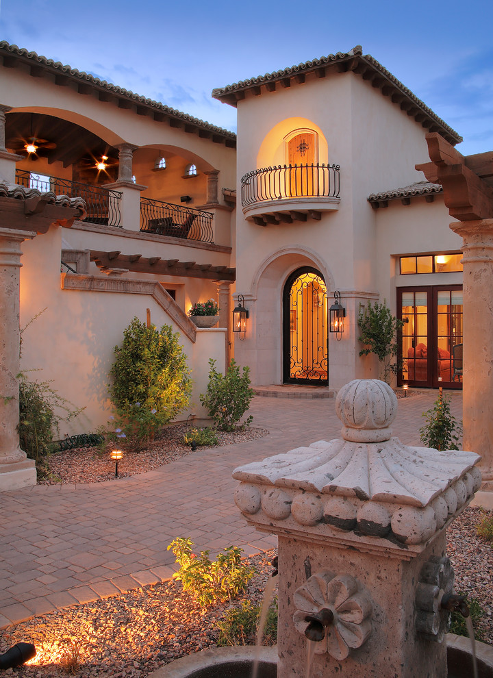 Inspiration for an expansive mediterranean entrance in Phoenix with a single front door, a metal front door and beige walls.