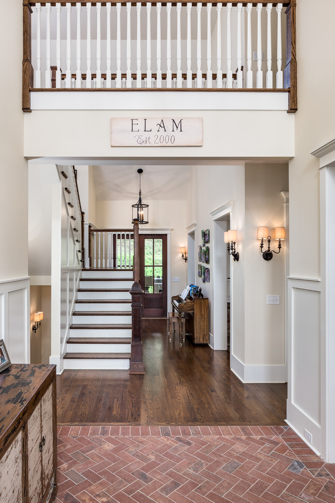 Photo of a medium sized traditional foyer in Nashville with beige walls, brick flooring, a single front door and a dark wood front door.
