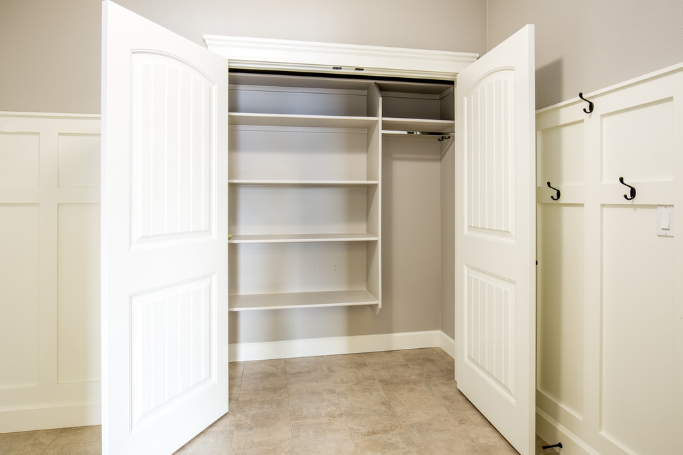 This is an example of a small farmhouse boot room in Boise with grey walls, a pivot front door and a white front door.