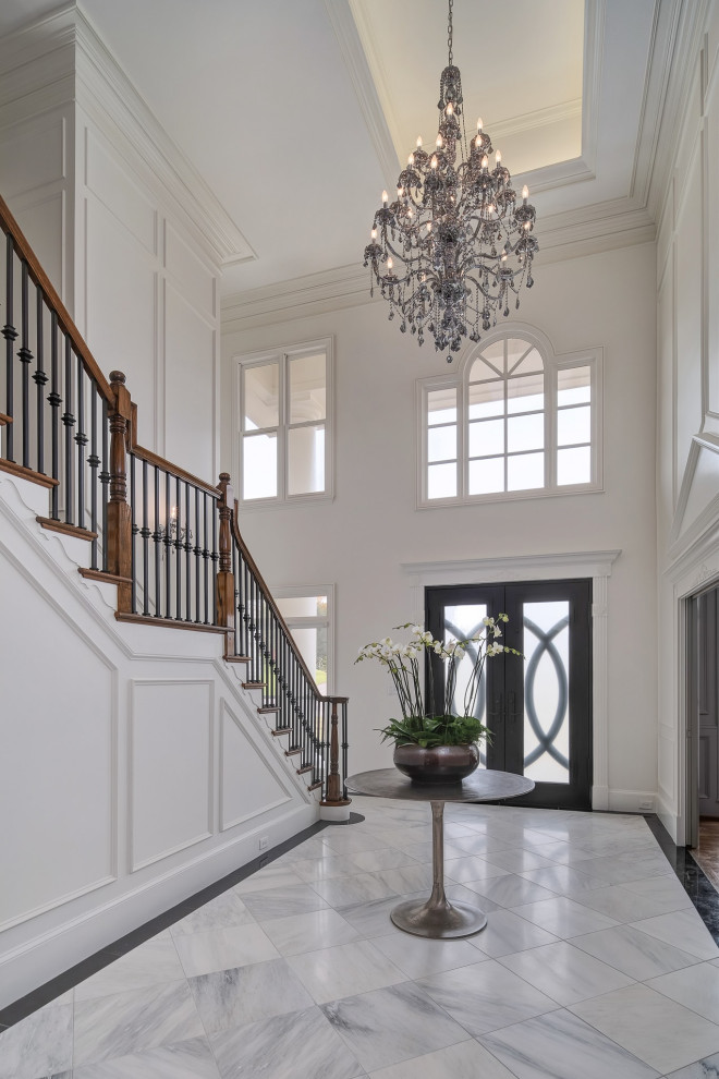 Photo of an expansive classic foyer in Birmingham with white walls, a double front door, a black front door and multi-coloured floors.