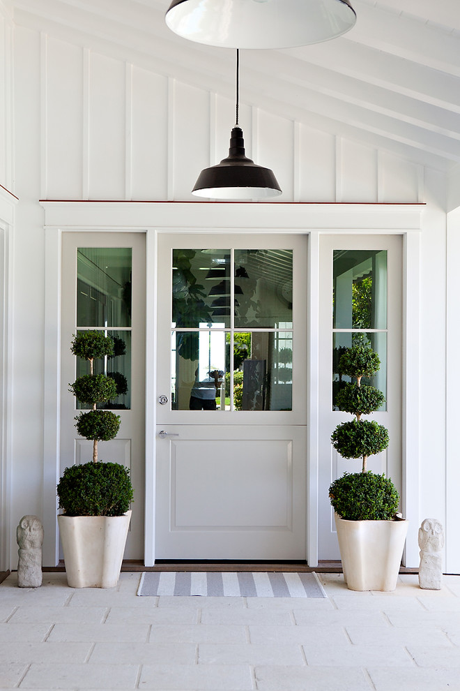 Design ideas for a coastal front door in Orange County with a single front door and a glass front door.