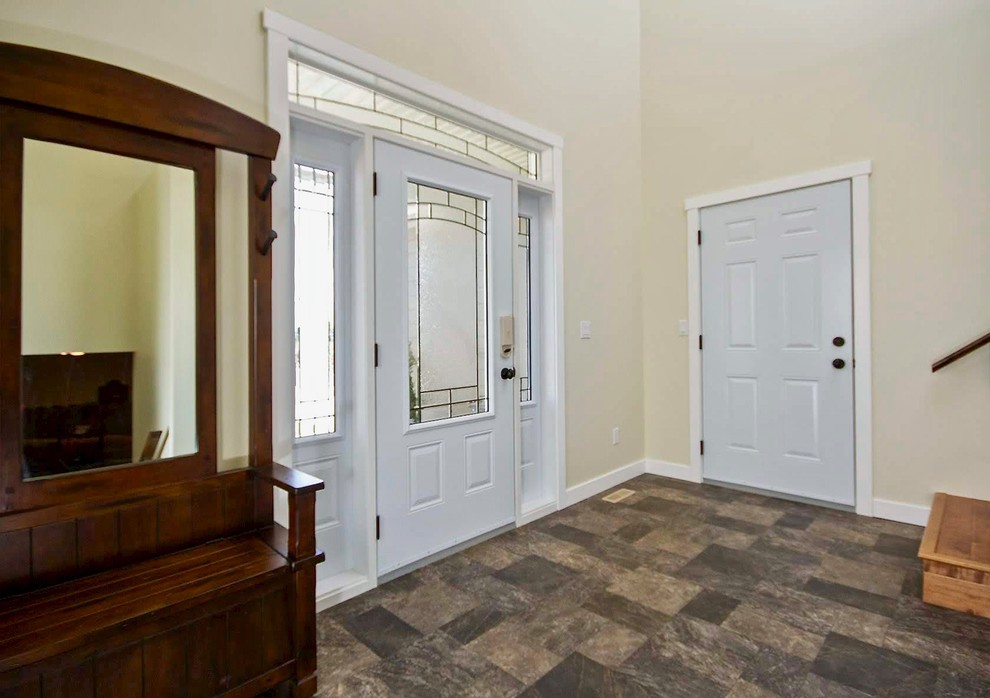 Minimalist vinyl floor and brown floor foyer photo in Calgary with yellow walls and a white front door