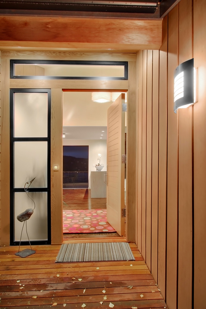 Example of a trendy entryway design in Seattle with a medium wood front door