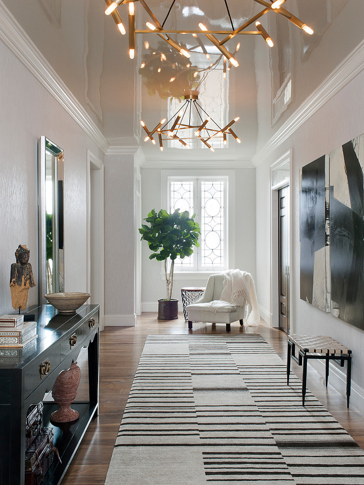 Entry hall - transitional medium tone wood floor and brown floor entry hall idea in New York with white walls