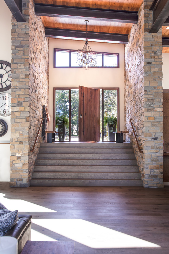 Expansive contemporary front door in Other with beige walls, dark hardwood flooring, a pivot front door, a medium wood front door, brown floors and a wood ceiling.