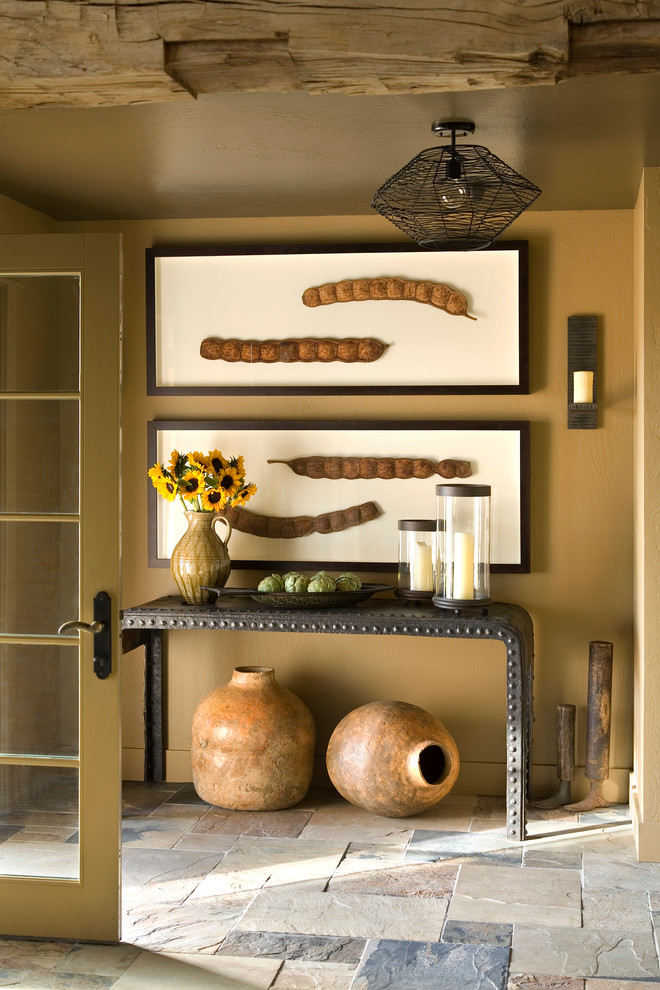 Entryway - small rustic ceramic tile entryway idea in Other with brown walls
