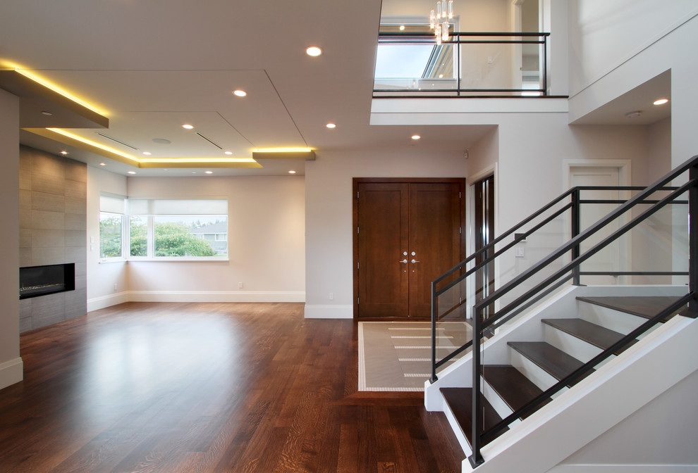 Entryway - mid-sized modern medium tone wood floor entryway idea in Vancouver with beige walls and a dark wood front door