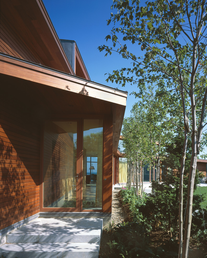 Photo of a medium sized contemporary entrance in Boston with a single front door and a glass front door.