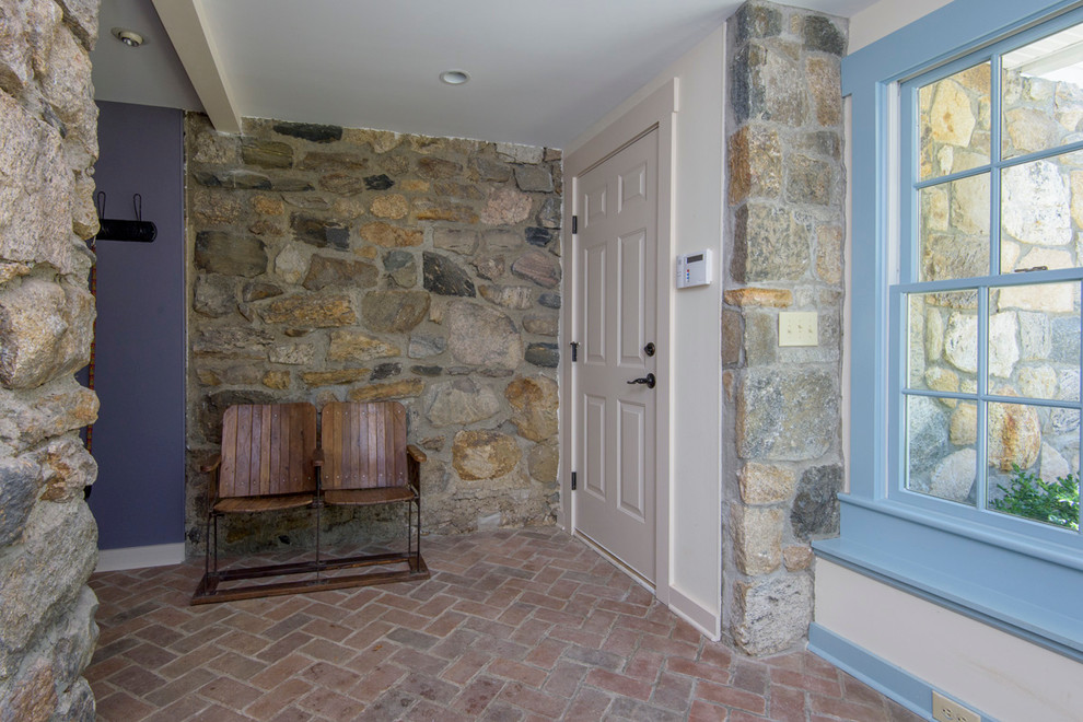 Ispirazione per un ingresso rustico di medie dimensioni con pareti blu, pavimento in mattoni, una porta a due ante e una porta bianca