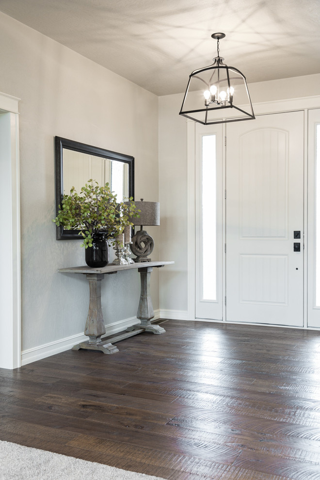 Medium sized country foyer in Other with grey walls, medium hardwood flooring, a single front door, a white front door, brown floors and feature lighting.