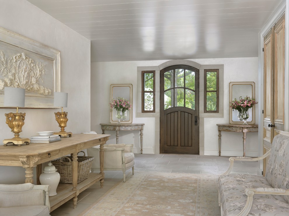 Aménagement d'un hall d'entrée romantique avec une porte simple, une porte en bois foncé, un sol gris et un mur gris.