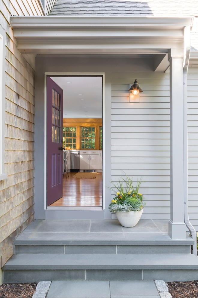 This is an example of a classic front door in Boston with grey walls, a single front door, a purple front door and grey floors.