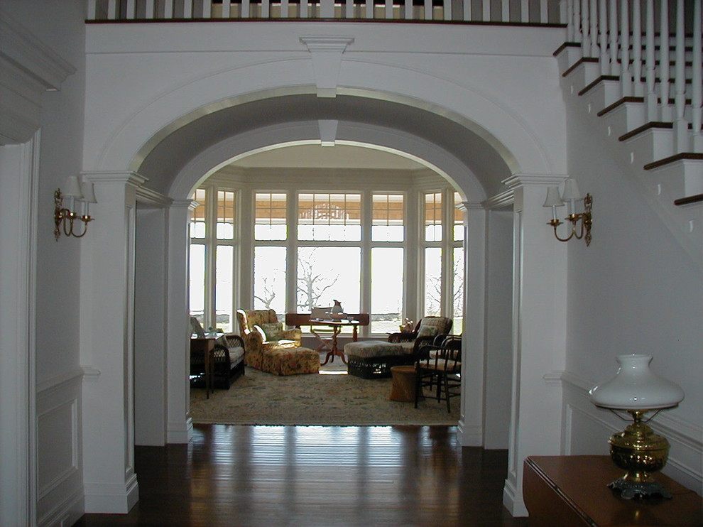 Inspiration for a mid-sized timeless dark wood floor foyer remodel in Boston with white walls