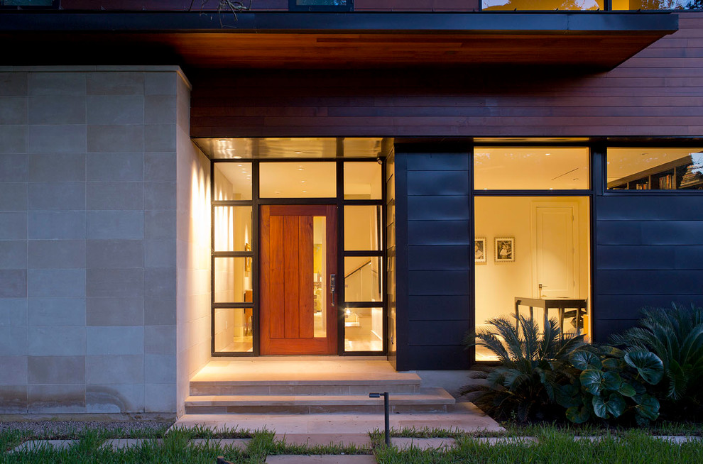Imagen de puerta principal contemporánea de tamaño medio con puerta pivotante y puerta de madera en tonos medios