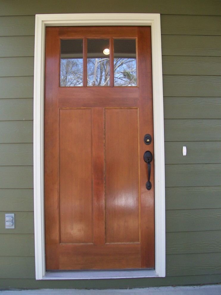 This is an example of a classic entrance in Atlanta with green walls, a single front door and a medium wood front door.