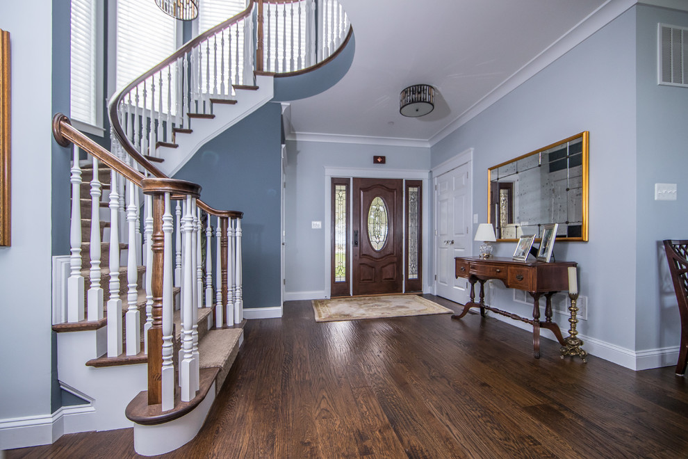 Photo of a medium sized traditional foyer in DC Metro with grey walls, dark hardwood flooring, a single front door, a black front door and brown floors.