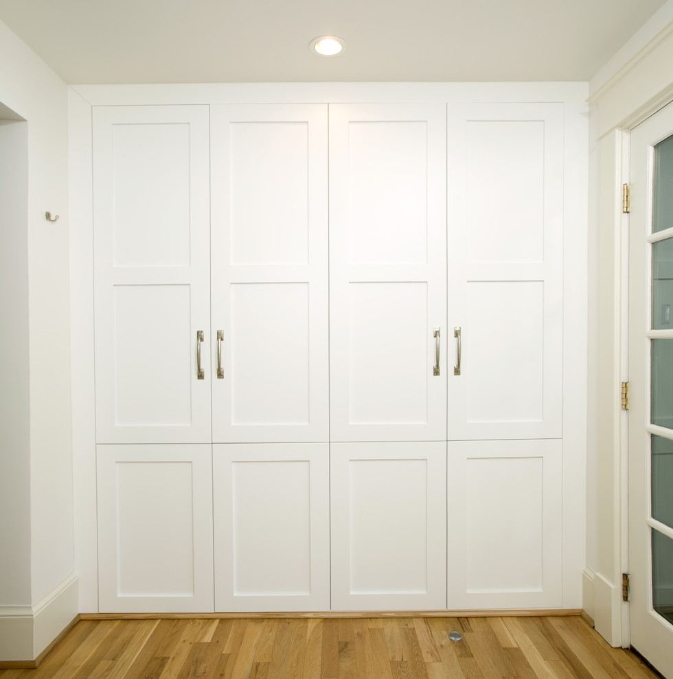Inspiration for a medium sized classic boot room in DC Metro with white walls, a single front door and light hardwood flooring.
