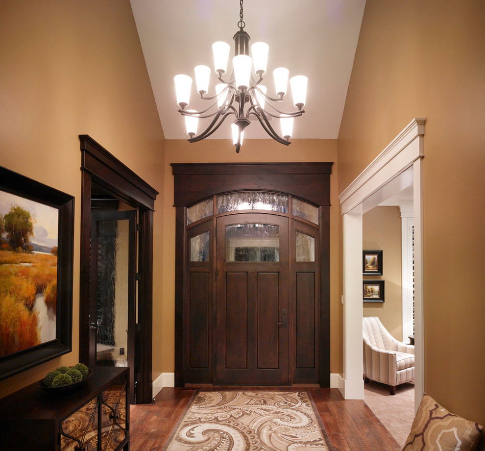 Example of a mid-sized classic dark wood floor entryway design in Salt Lake City with brown walls and a dark wood front door