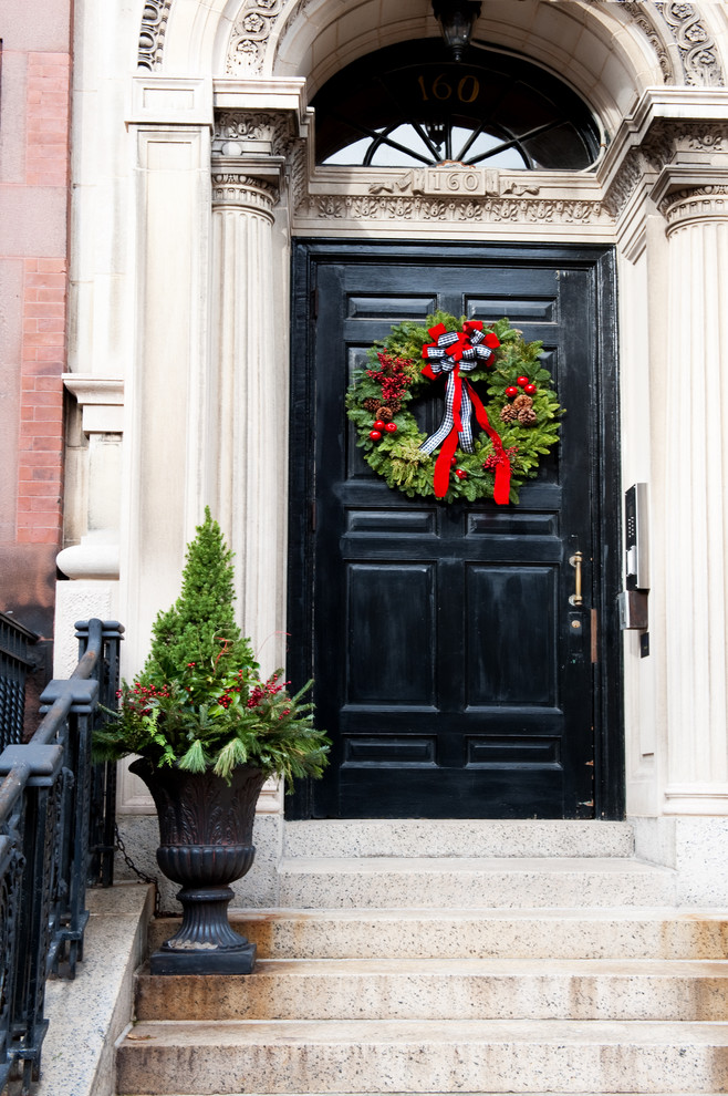 Example of a classic entryway design in Boston with a black front door